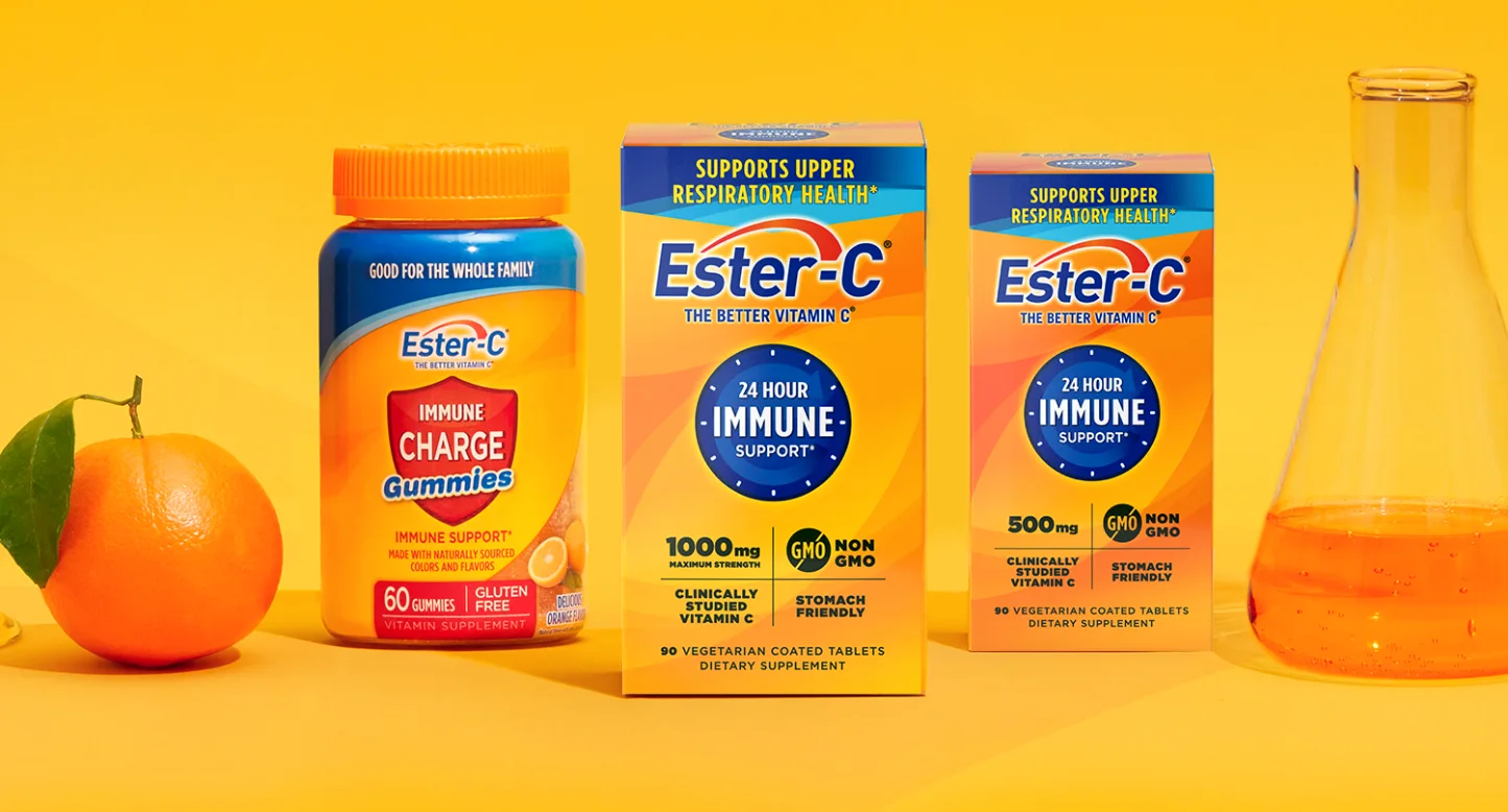 Ester-C 1000 mg and 500 mg boxes beside an orange and a glass flask
